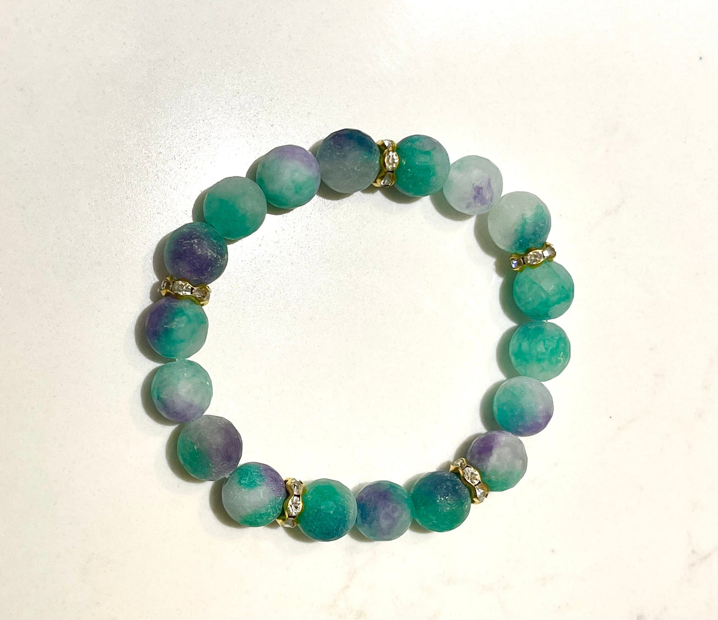 Aqua and a touch of purple are stunning together accented with gold and gold leaf cuff. Bead bracelet set.