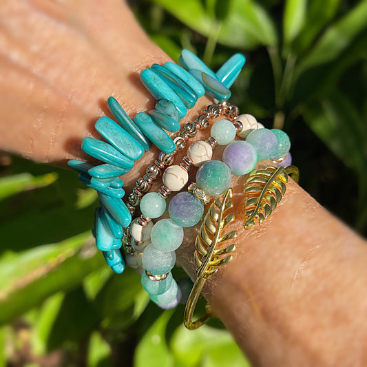 Aqua and a touch of purple are stunning together accented with gold and gold leaf cuff. Bead bracelet set.