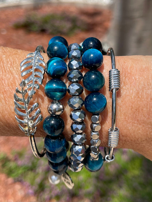 Gorgeous blue cats eye bead bracelets with silver leaf cuff and silver coil design cuff.