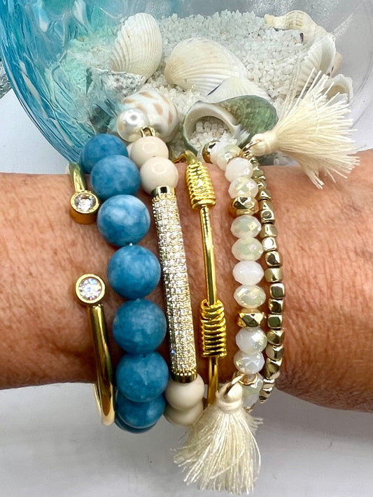 Dainty bracelet stack that's shows style!  Beautiful blue chalcedony beads and cream and gold bracelet with tassels.  So cute!