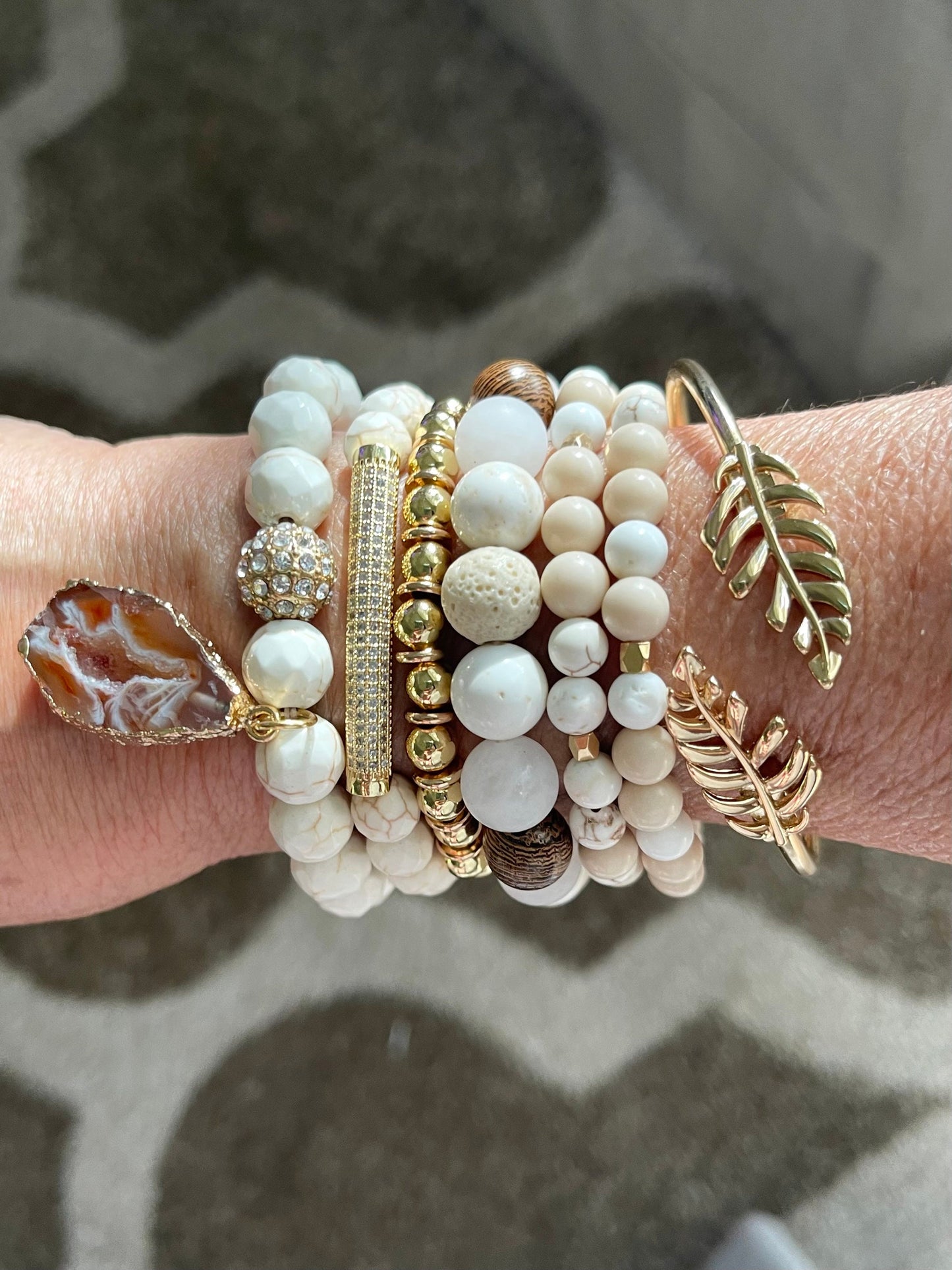 Howlite, lava rock and wooden beads make a this a striking set.  Combined with gold leaf cuff and gold bead bracelet. 6 piece set