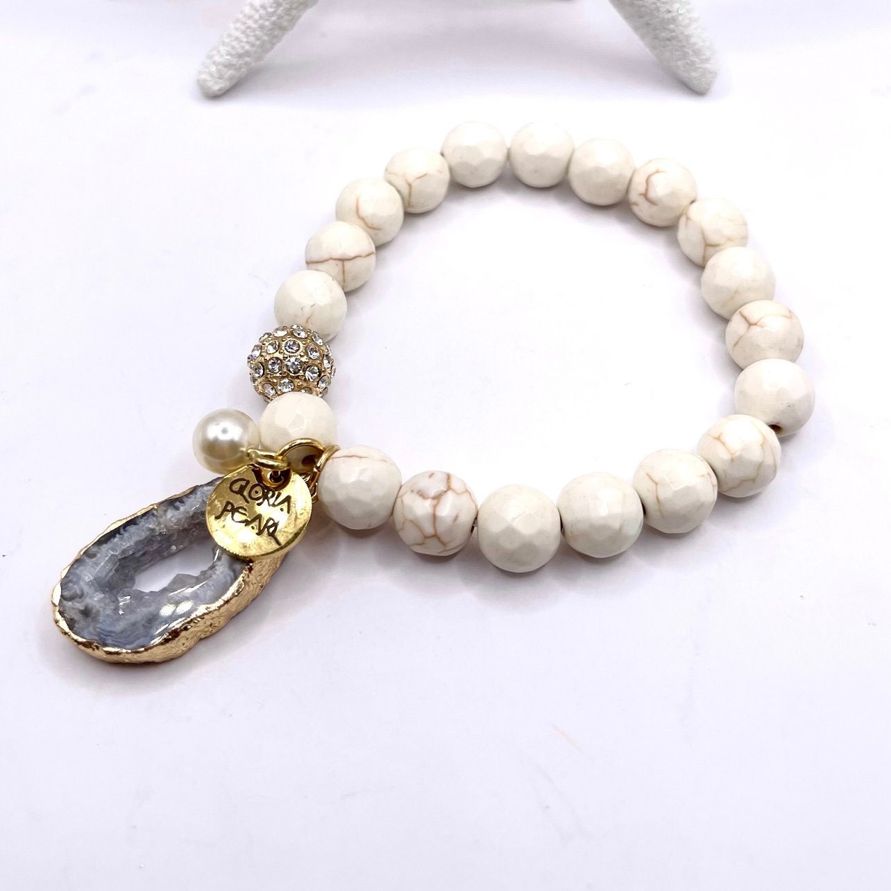 Howlite, lava rock and wooden beads make a this a striking set.  Combined with gold leaf cuff and gold bead bracelet. 6 piece set